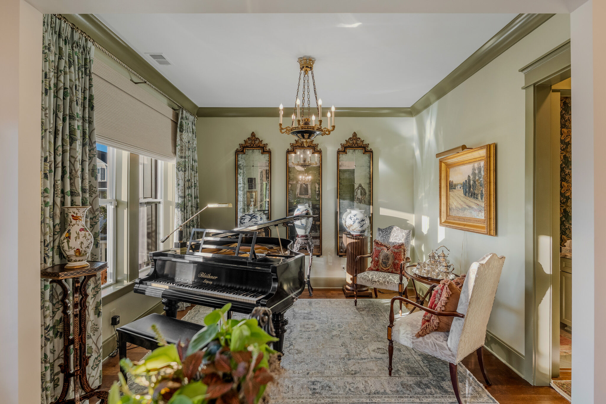 Music room with grand piano and gilt mirrors