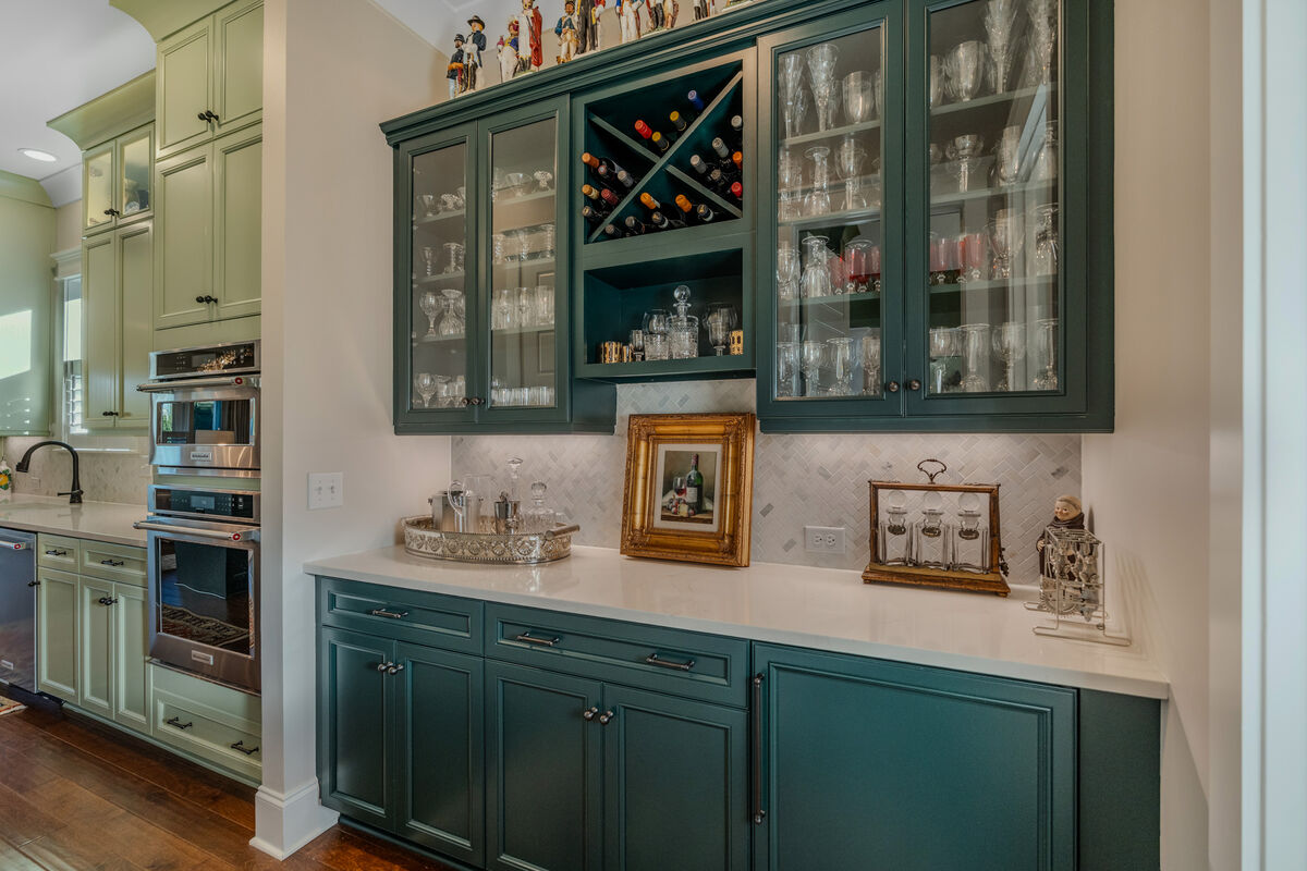 Butler's pantry with glass-front cabinets and wine rack