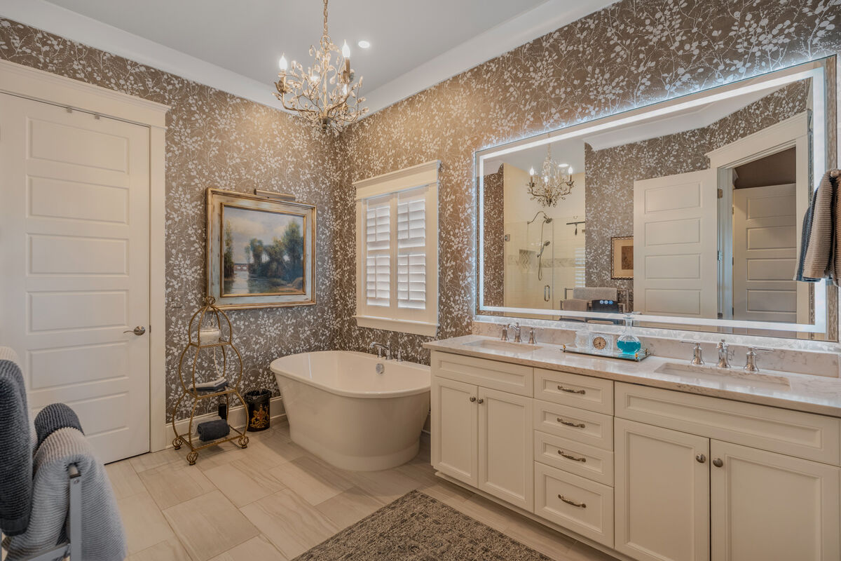 Primary bath with freestanding tub and lighted mirror